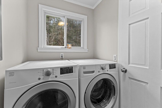 laundry room with washing machine and dryer and ornamental molding