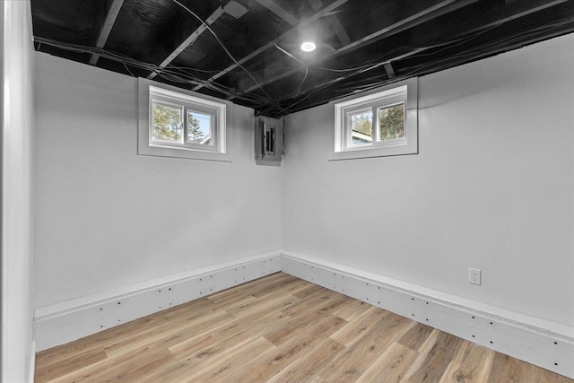 basement featuring hardwood / wood-style flooring and a healthy amount of sunlight