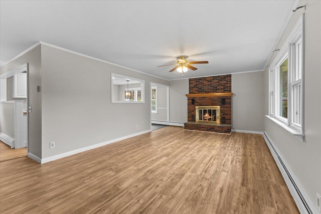 unfurnished living room featuring light hardwood / wood-style flooring, a fireplace, a baseboard heating unit, and crown molding