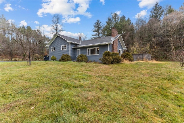 view of side of home featuring a lawn