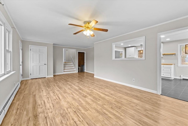 unfurnished living room featuring ceiling fan, hardwood / wood-style floors, ornamental molding, and a baseboard heating unit