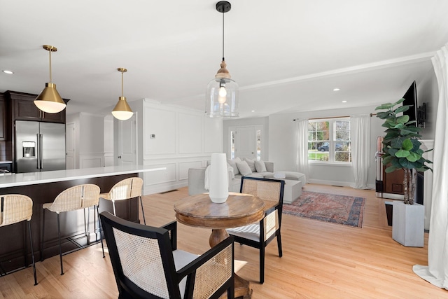 dining space with light hardwood / wood-style floors