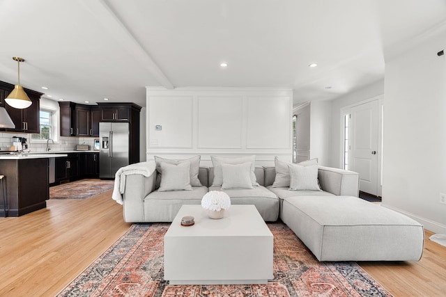 living room featuring sink and wood-type flooring