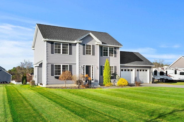 view of front facade featuring a front yard and a garage