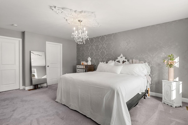 carpeted bedroom featuring a notable chandelier