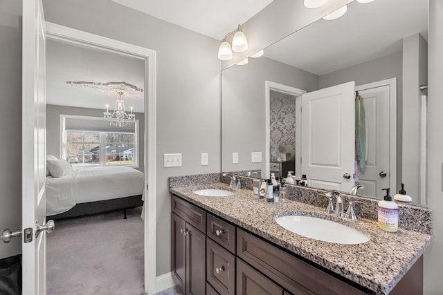 bathroom with vanity and a notable chandelier