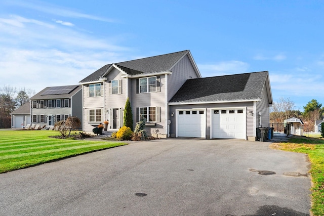 view of front of house with a garage and a front lawn