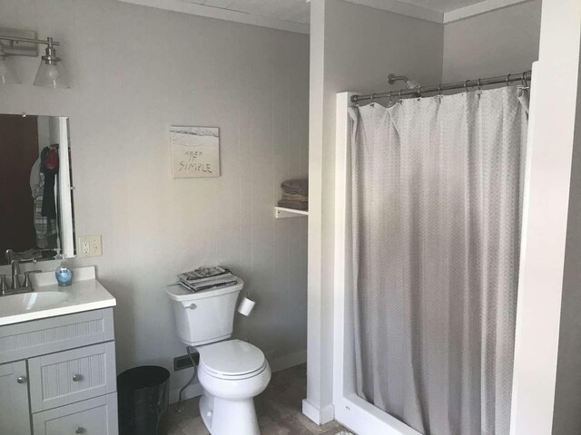 bathroom with a shower with shower curtain, vanity, toilet, and tile patterned floors