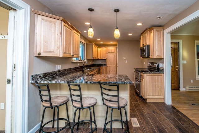 390 Simonds Rd, Dalton, NH 03598 - kitchen with appliances with stainless steel finishes, a sink, light brown cabinetry, a baseboard heating unit, and recessed lighting