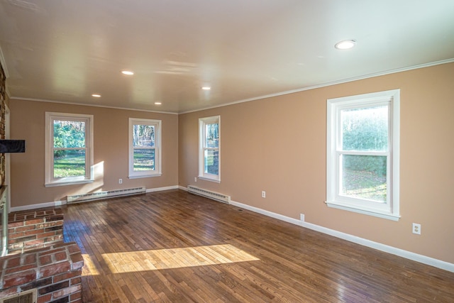 spare room featuring dark hardwood / wood-style flooring, a baseboard radiator, and plenty of natural light