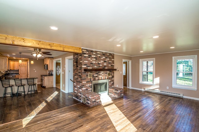 unfurnished living room with a fireplace, dark wood-type flooring, ceiling fan, and a baseboard heating unit