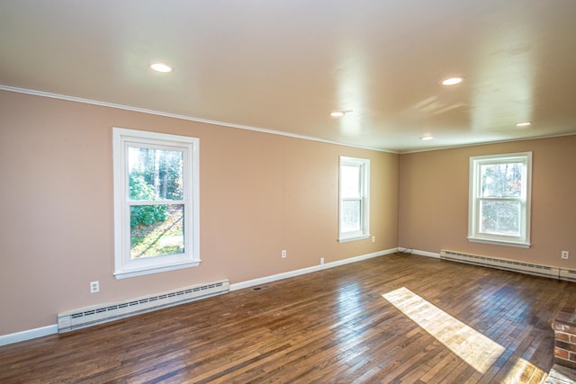 unfurnished room featuring dark hardwood / wood-style floors, a wealth of natural light, and a baseboard radiator