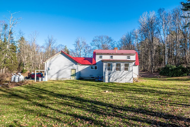 rear view of property featuring a yard