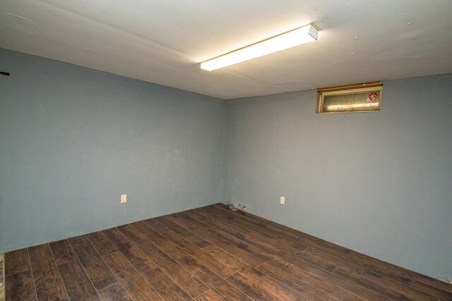basement with dark wood-type flooring