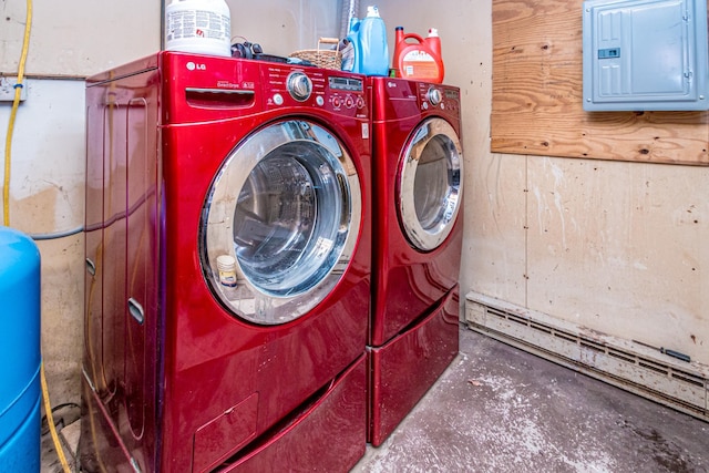 washroom with a baseboard heating unit, electric panel, and washing machine and clothes dryer