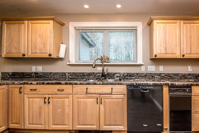 kitchen featuring dark stone countertops, sink, and black dishwasher