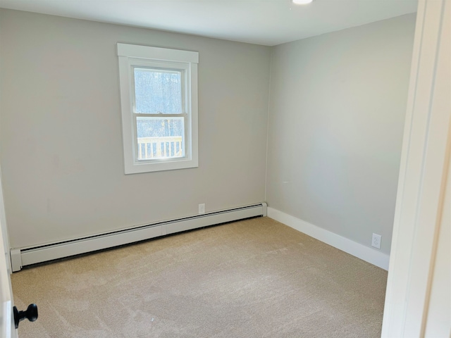 unfurnished room with light colored carpet and a baseboard radiator