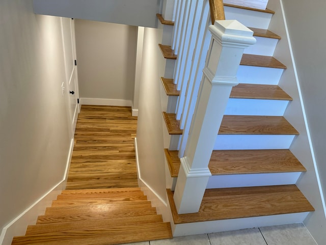 stairs featuring hardwood / wood-style floors