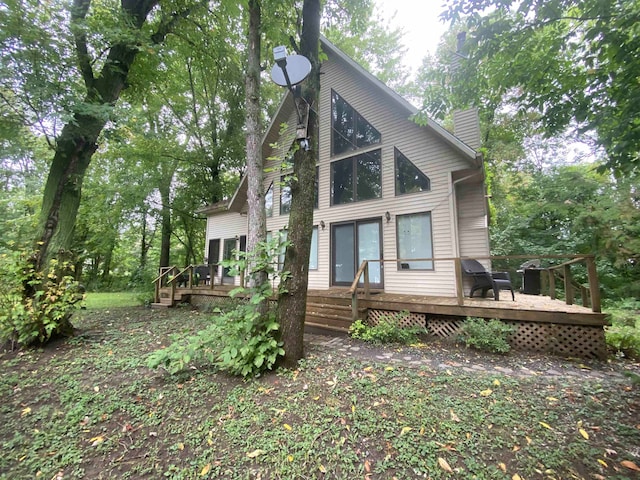 rear view of property featuring a deck