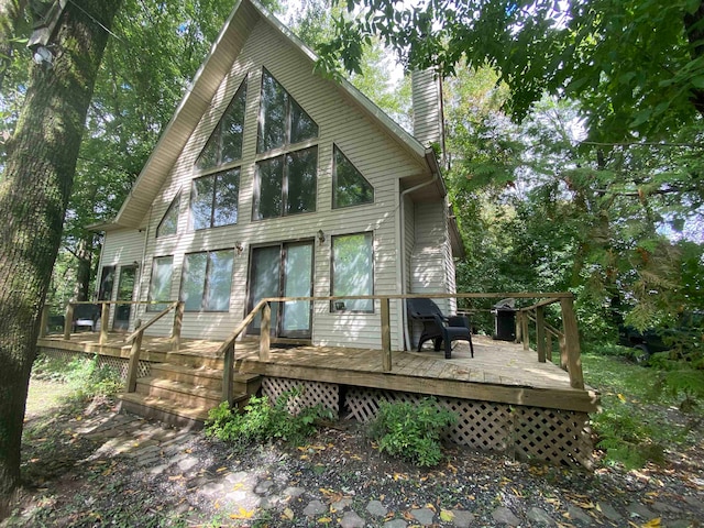 rear view of property featuring a deck