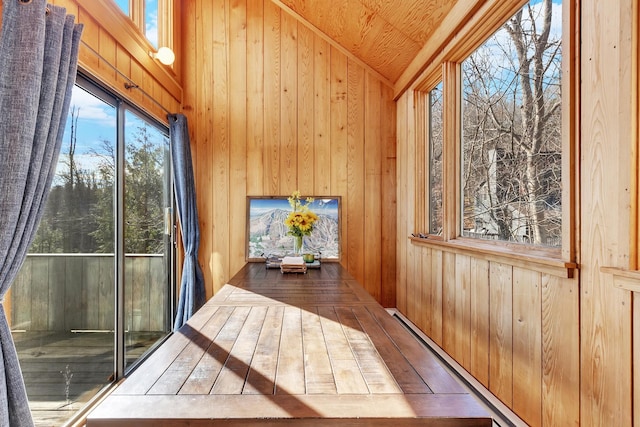 unfurnished sunroom featuring vaulted ceiling and wood ceiling