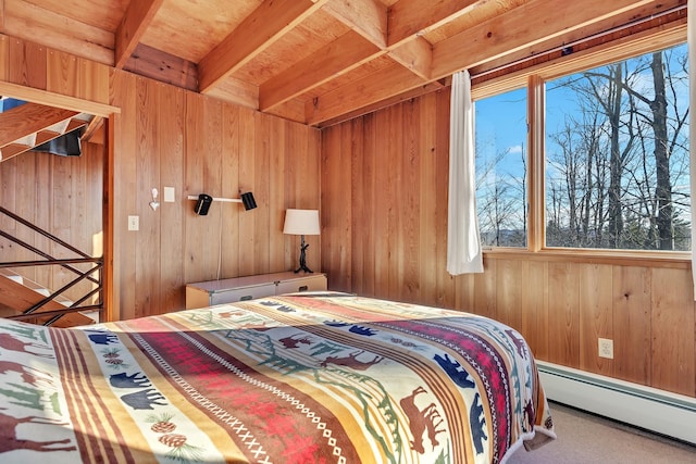 bedroom featuring wooden walls, beamed ceiling, and a baseboard heating unit