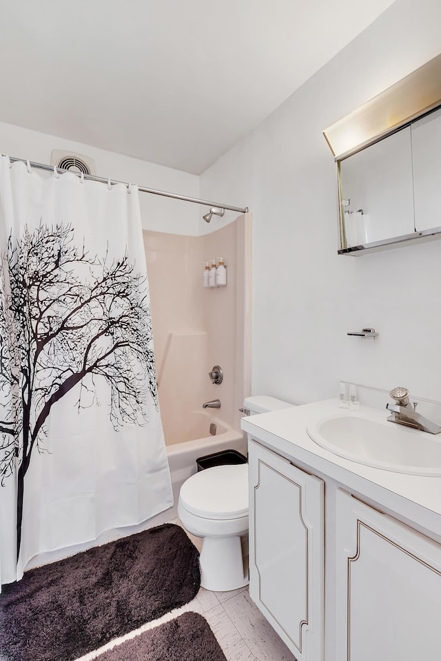 full bathroom with tile patterned flooring, shower / bath combo with shower curtain, vanity, and toilet