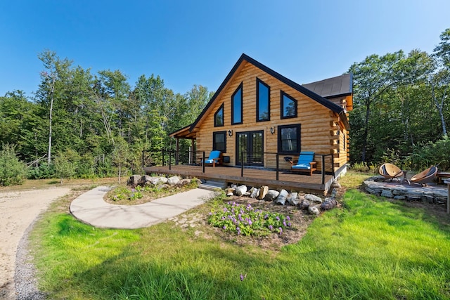 back of property with a wooden deck and french doors