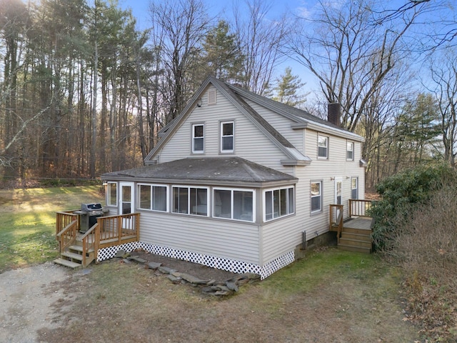 back of house featuring a deck and a sunroom