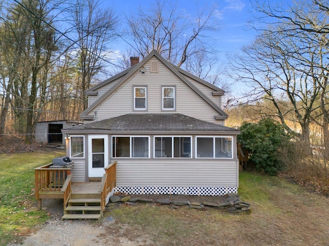 rear view of house featuring a lawn