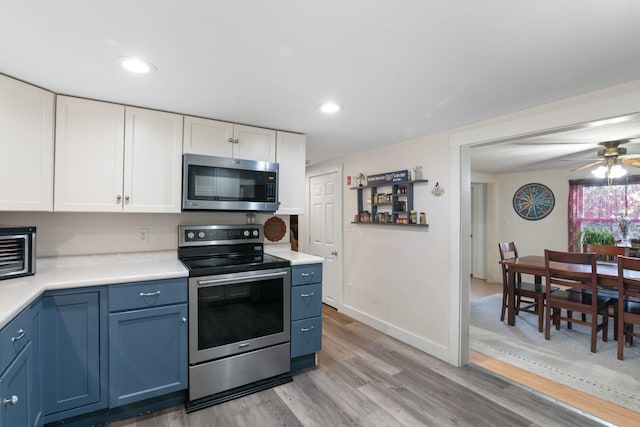 kitchen featuring white cabinets, stainless steel appliances, ceiling fan, light hardwood / wood-style flooring, and blue cabinets