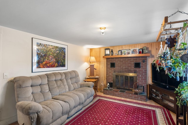 living room featuring a fireplace and wood walls