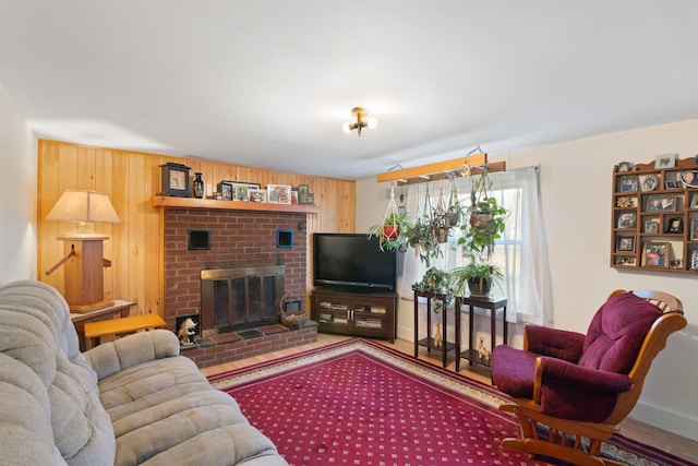 living room with wooden walls and a fireplace