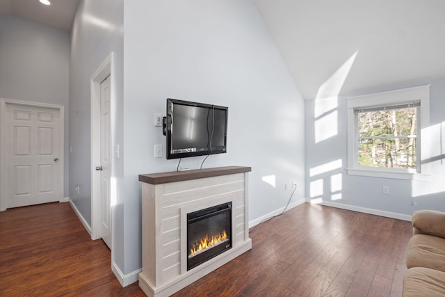 unfurnished living room with dark hardwood / wood-style flooring and high vaulted ceiling