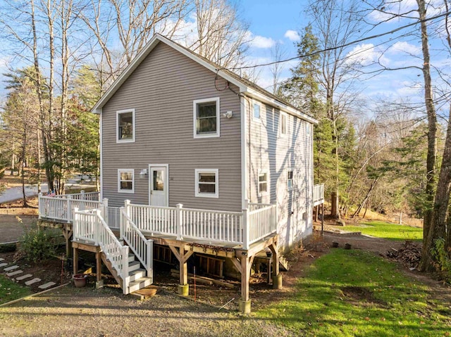 rear view of house featuring a wooden deck