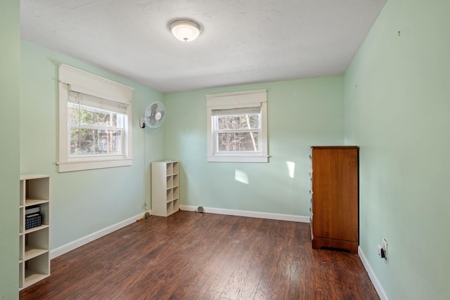 unfurnished room with dark hardwood / wood-style flooring