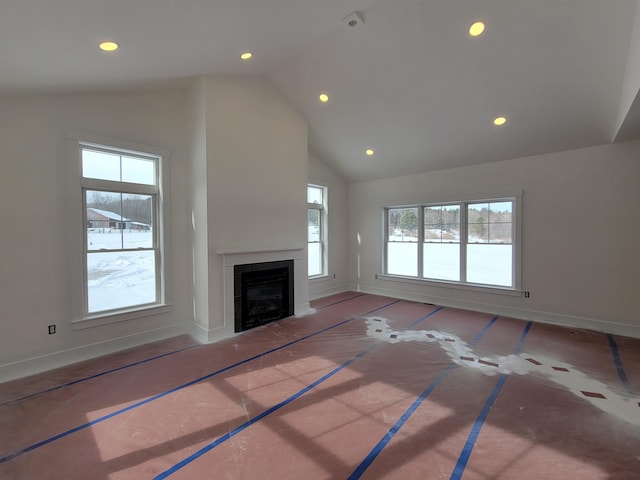 unfurnished living room featuring high vaulted ceiling