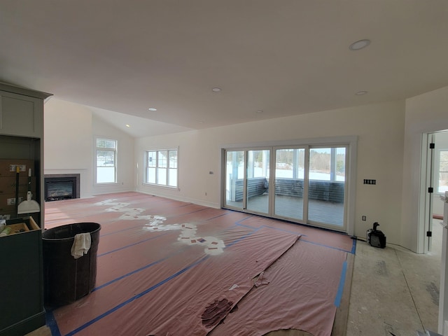 living room featuring lofted ceiling