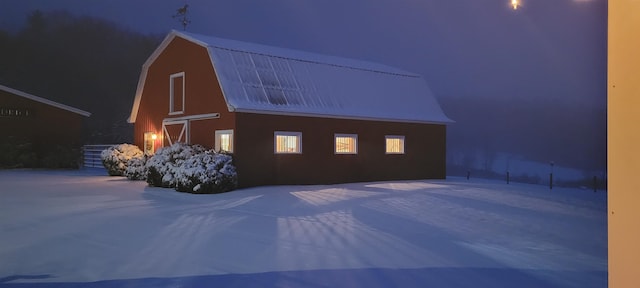 view of snow covered exterior featuring an outbuilding