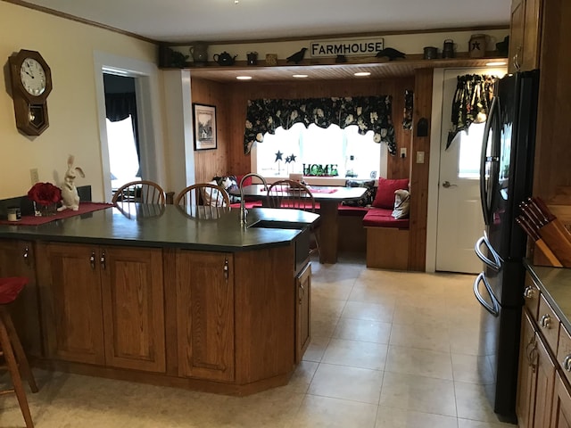 kitchen with black refrigerator and a kitchen island