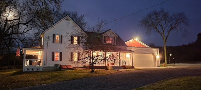 view of front facade featuring a porch and a garage