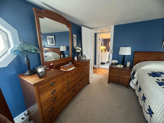 carpeted bedroom featuring a textured ceiling