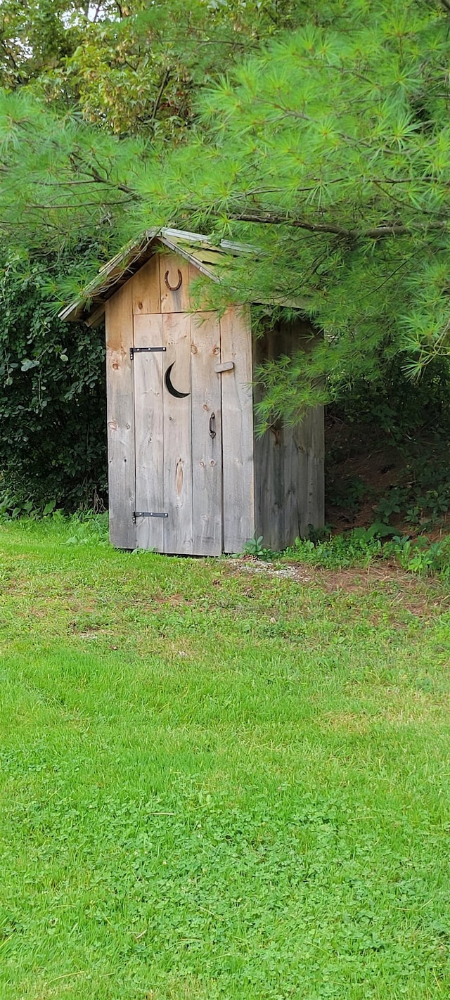 view of outbuilding with a lawn