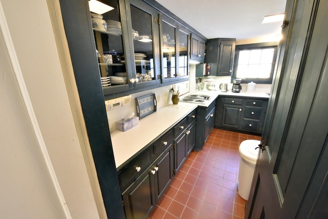 bar featuring white gas cooktop and dark tile patterned flooring