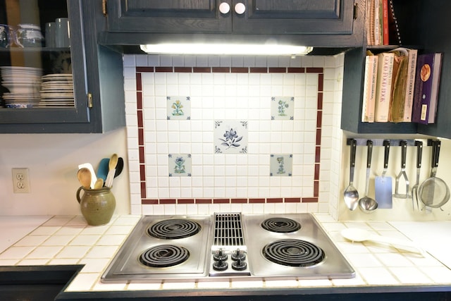 kitchen featuring tile countertops, decorative backsplash, and stainless steel gas stovetop