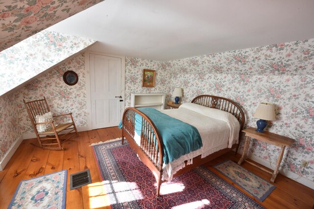 bedroom with wood-type flooring