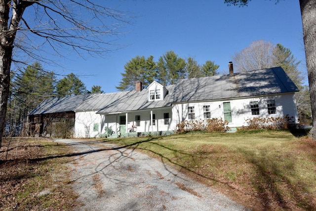 back of property featuring a lawn and a porch