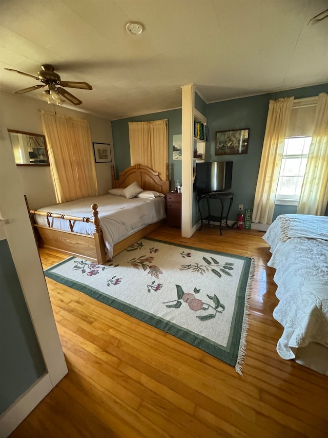 bedroom with ceiling fan and hardwood / wood-style floors