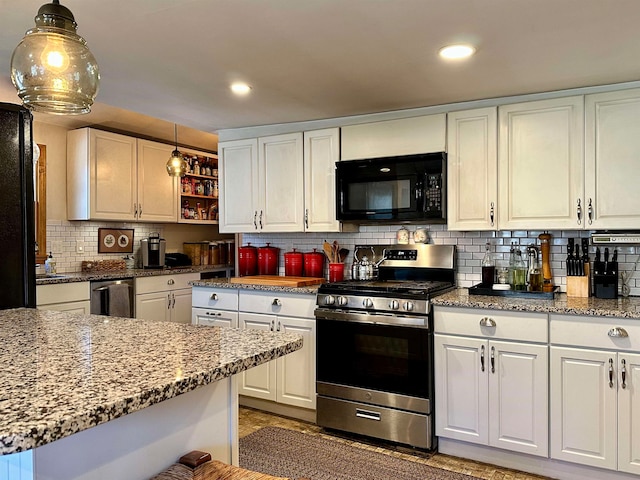 kitchen with white cabinets, decorative backsplash, pendant lighting, and stainless steel range