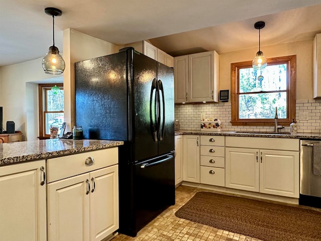 kitchen featuring a healthy amount of sunlight, white cabinetry, and sink